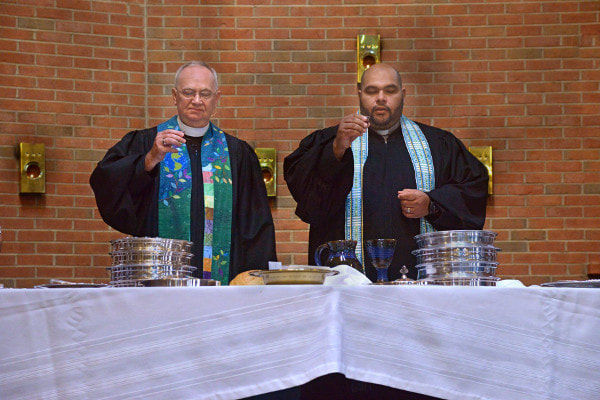 Picture of pastors serving communion